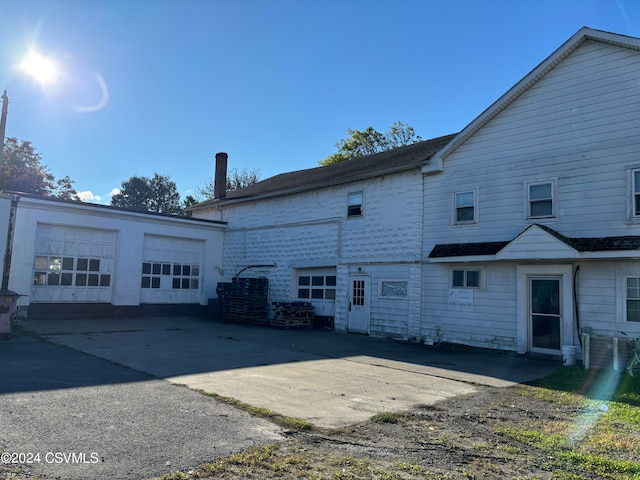 rear view of house featuring a garage