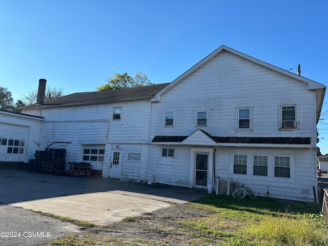 back of house featuring a garage