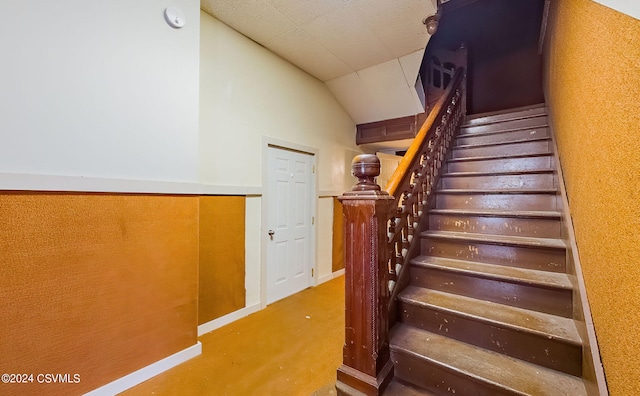 stairs with lofted ceiling