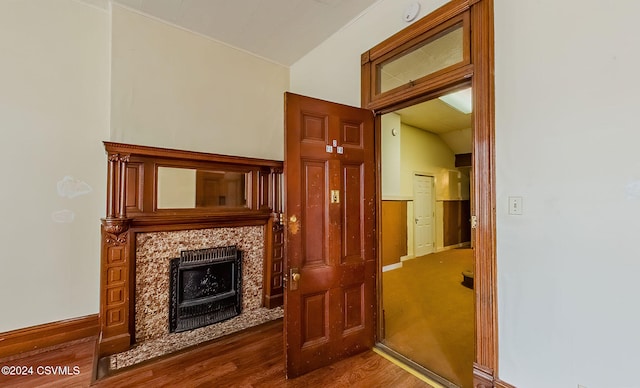 interior space featuring lofted ceiling, a fireplace, and hardwood / wood-style floors