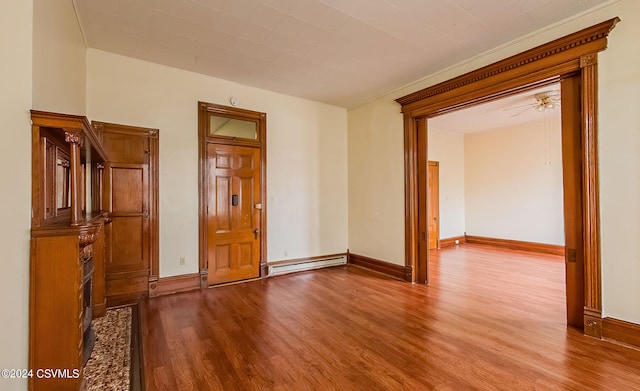 empty room with ceiling fan, a baseboard heating unit, and light wood-type flooring