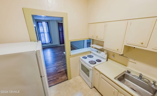 kitchen with white appliances, light hardwood / wood-style floors, sink, and baseboard heating