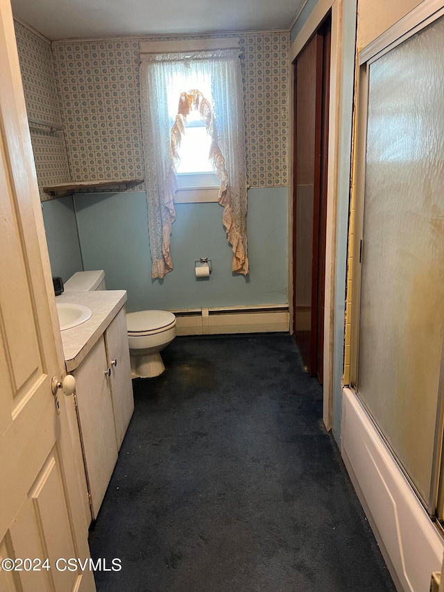 full bathroom with vanity, combined bath / shower with glass door, a baseboard heating unit, and toilet