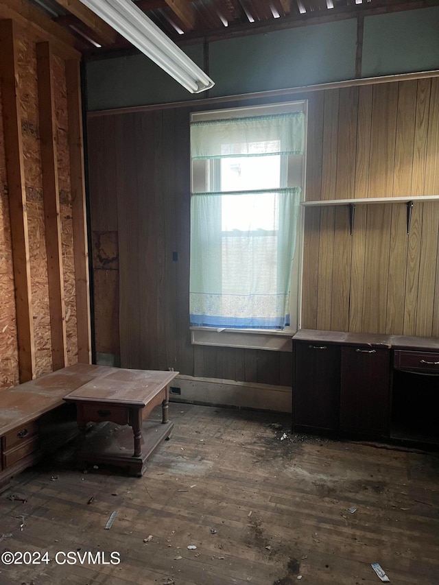 mudroom with dark hardwood / wood-style floors and wood walls