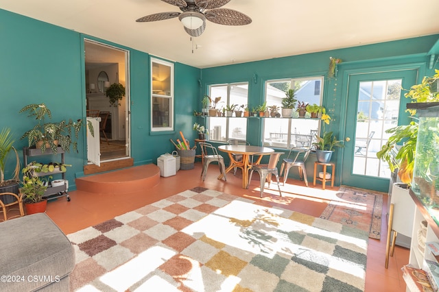 sunroom / solarium featuring ceiling fan