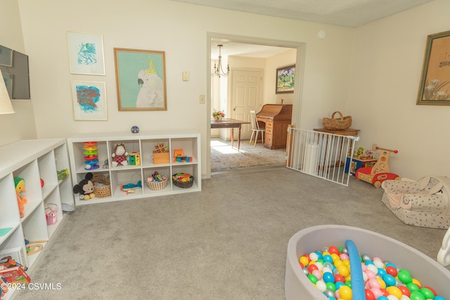 playroom with light carpet and a notable chandelier