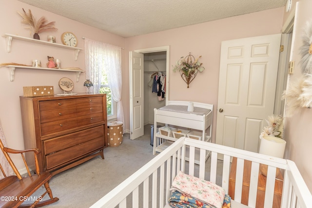 bedroom with a closet, a textured ceiling, and carpet flooring