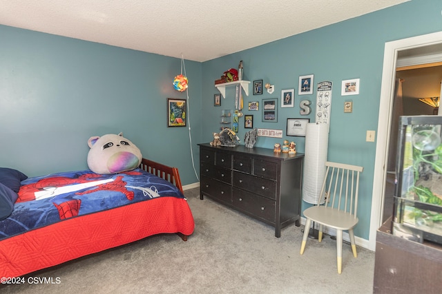 bedroom featuring a textured ceiling and light colored carpet