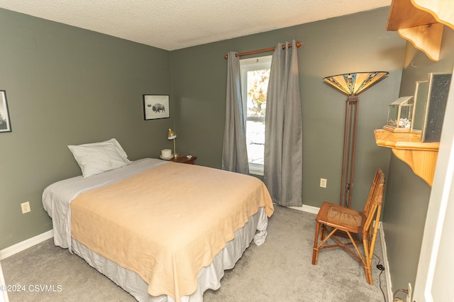 carpeted bedroom featuring a textured ceiling