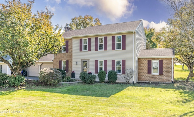 view of front of property with a front lawn and a garage