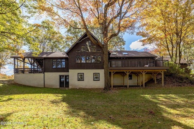 back of house with a lawn and a wooden deck