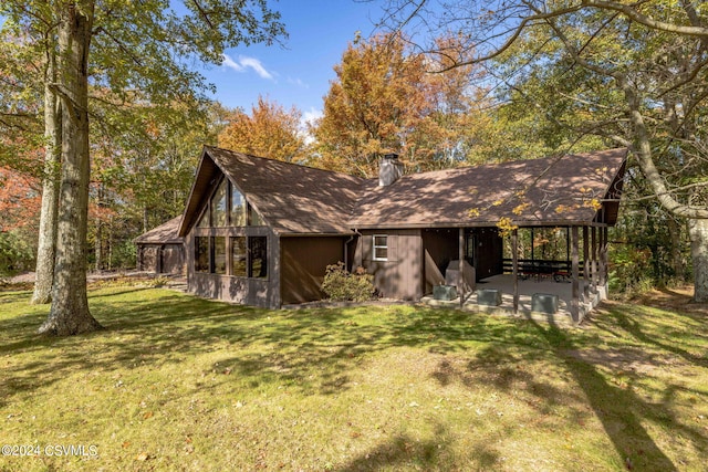 exterior space with a front yard, a patio area, and a chimney