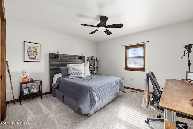 bedroom featuring light carpet, a ceiling fan, visible vents, and baseboards