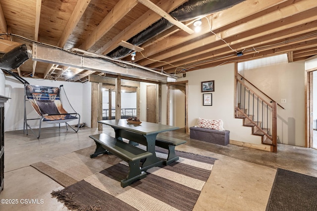 interior space featuring unfinished concrete floors and stairs