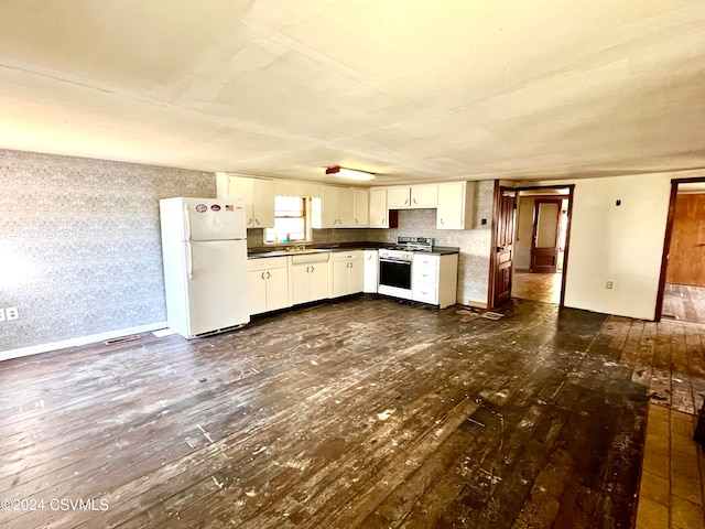 kitchen featuring sink, white cabinets, white appliances, and dark hardwood / wood-style flooring