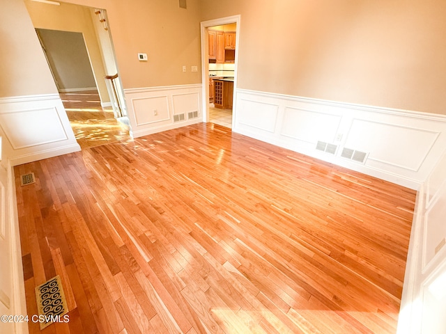 spare room with light hardwood / wood-style flooring