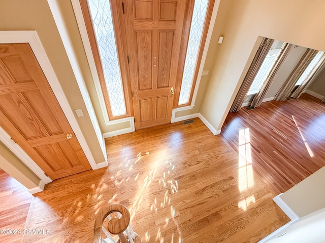 entrance foyer with a high ceiling and light wood-type flooring