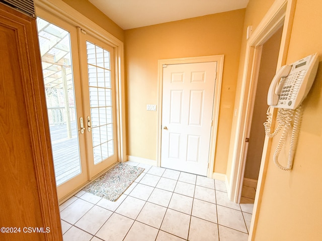 doorway to outside featuring french doors and light tile patterned floors