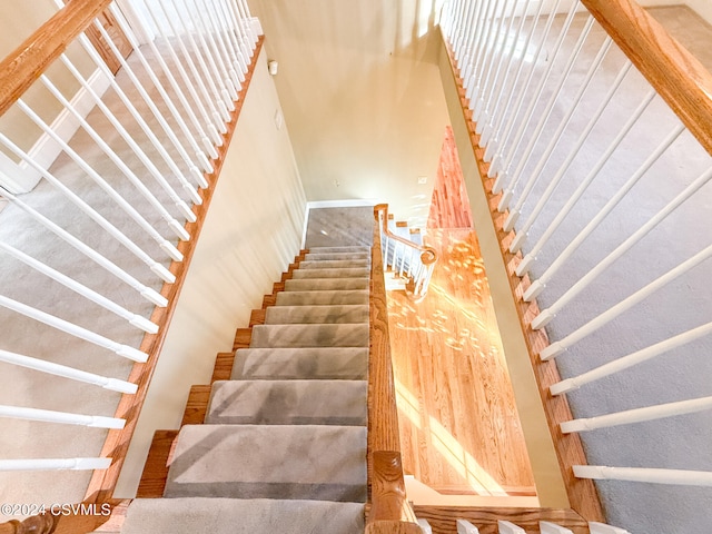 stairs featuring hardwood / wood-style floors