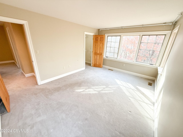 unfurnished bedroom with light colored carpet