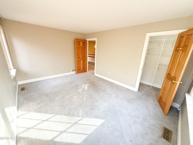 unfurnished bedroom featuring carpet floors and a closet