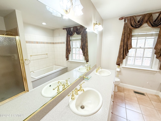 full bathroom featuring toilet, vanity, tile patterned flooring, and separate shower and tub