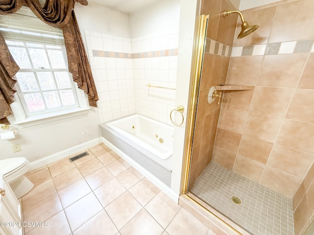 bathroom with toilet, tile patterned floors, and separate shower and tub