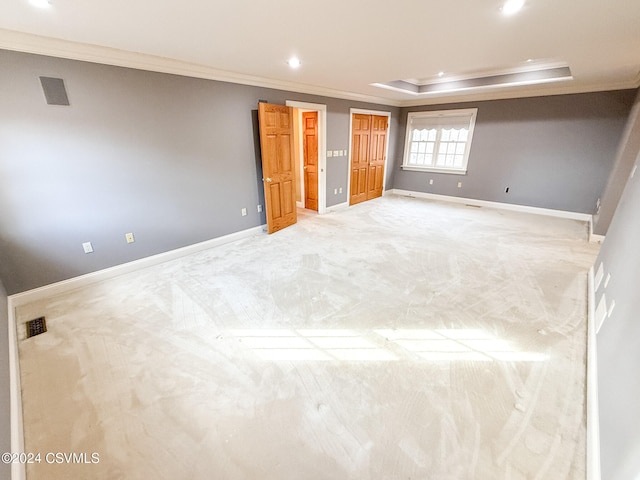 basement with ornamental molding and light colored carpet