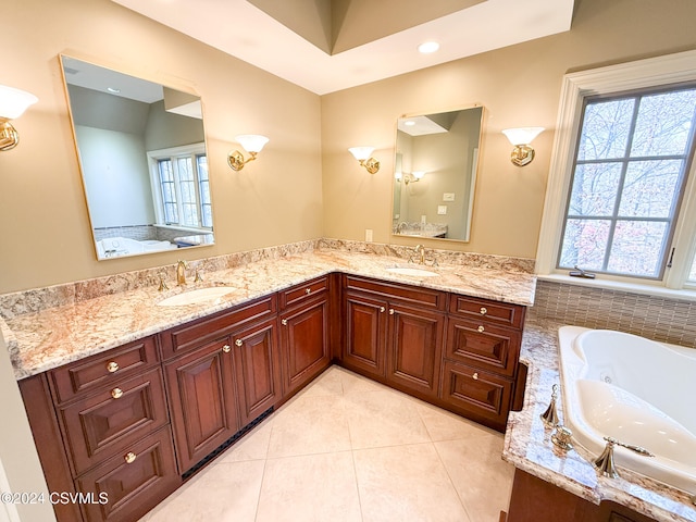 bathroom with vanity, a tub, and tile patterned floors