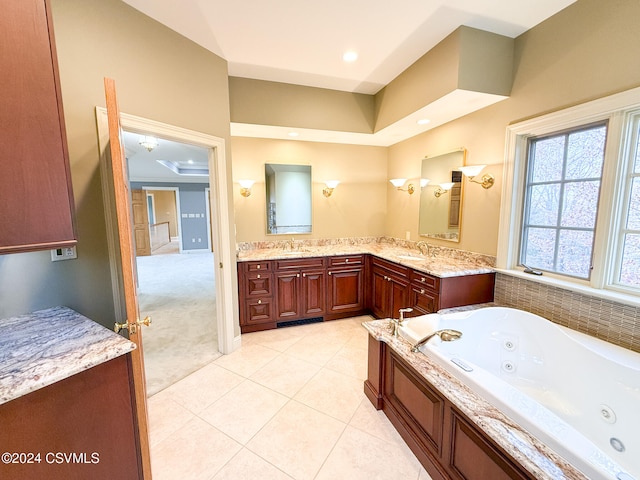 bathroom featuring a bathing tub, vanity, and tile patterned floors