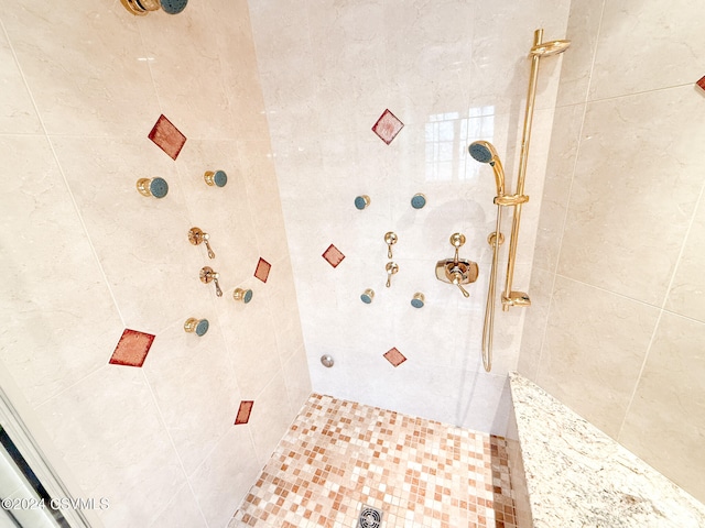 bathroom with a tile shower