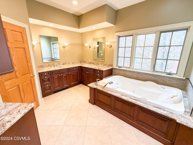 bathroom with a tub, tile patterned flooring, and vanity