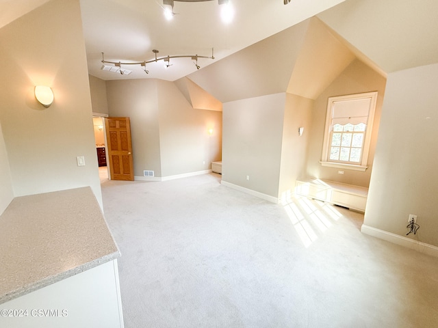 bonus room featuring lofted ceiling and light colored carpet