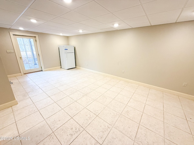 tiled spare room with a drop ceiling