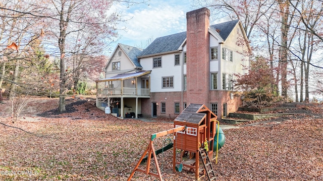 rear view of house with a playground