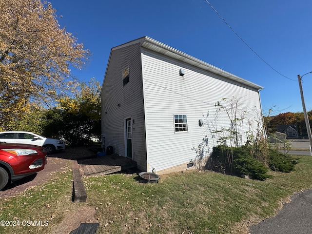 view of property exterior with a lawn