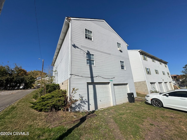 view of home's exterior featuring a yard and a garage