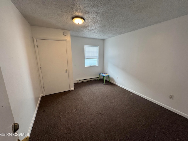 carpeted spare room featuring a baseboard radiator and a textured ceiling