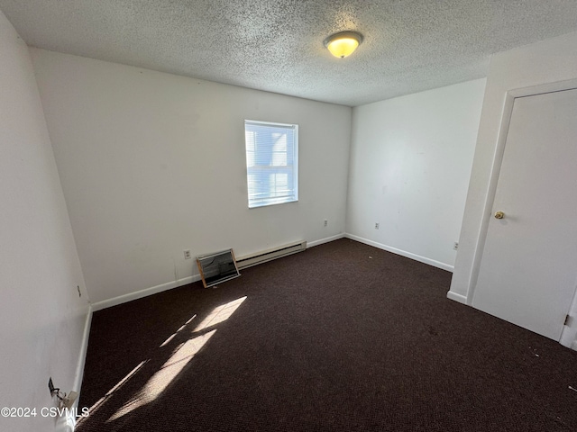 carpeted empty room with a baseboard radiator and a textured ceiling