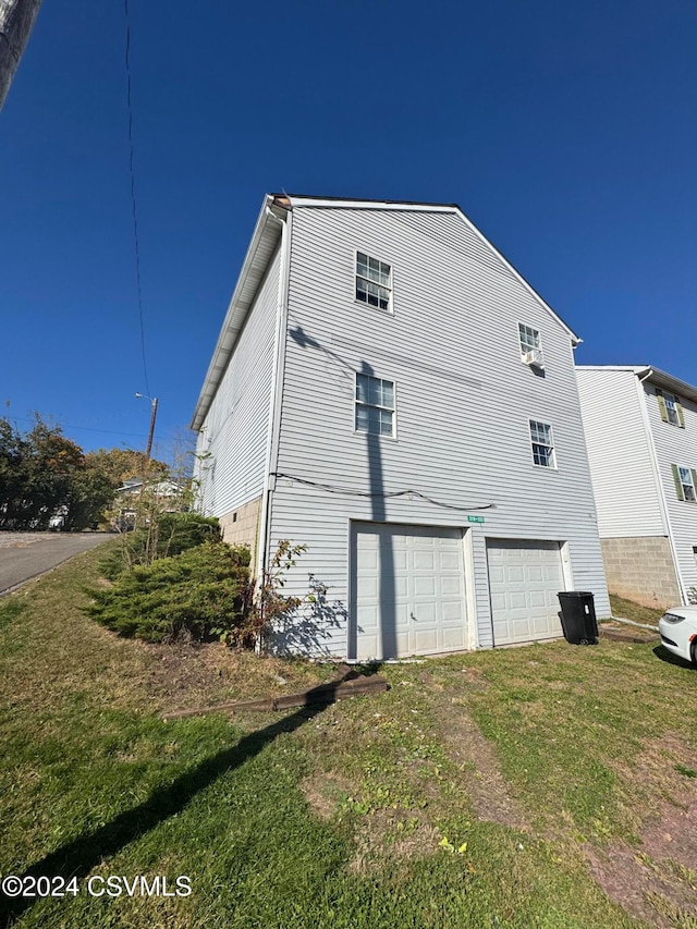 view of property exterior featuring a yard and a garage