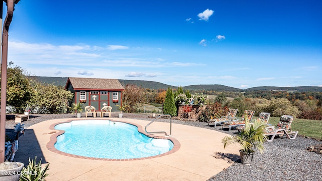 view of swimming pool featuring a patio and a mountain view