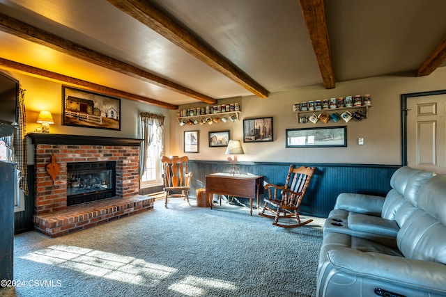 living room with carpet floors, a fireplace, and beamed ceiling