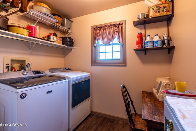 clothes washing area featuring dark hardwood / wood-style flooring and washer and dryer