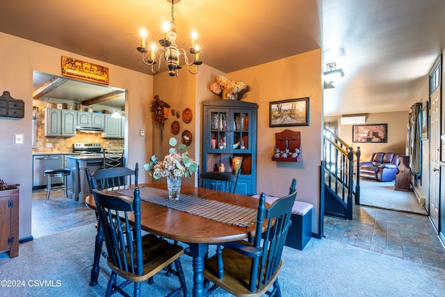 dining room with a wall unit AC and a chandelier