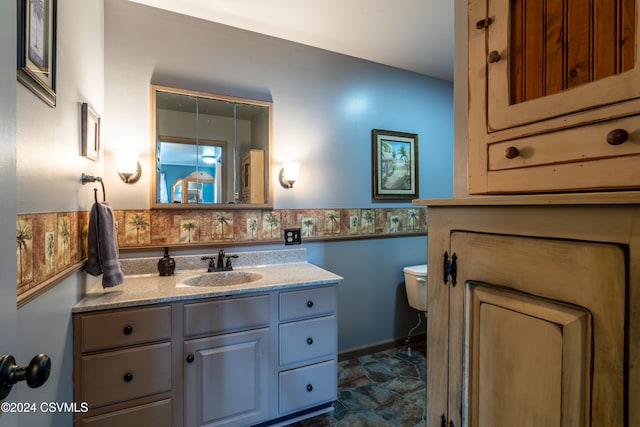 bathroom featuring vanity and toilet