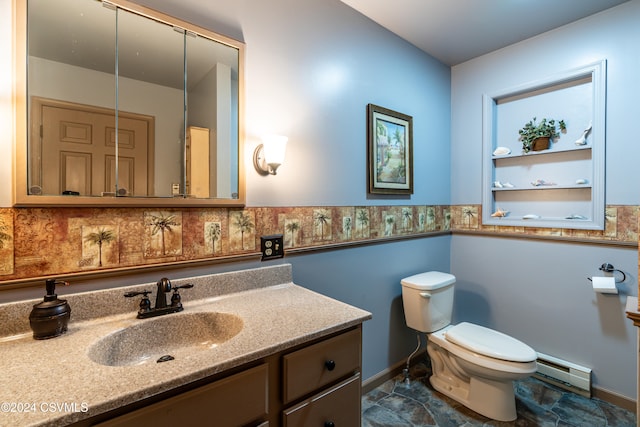 bathroom featuring vanity, a baseboard heating unit, and toilet