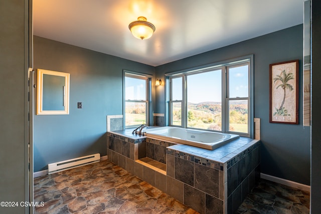 bathroom with a baseboard radiator and tiled tub