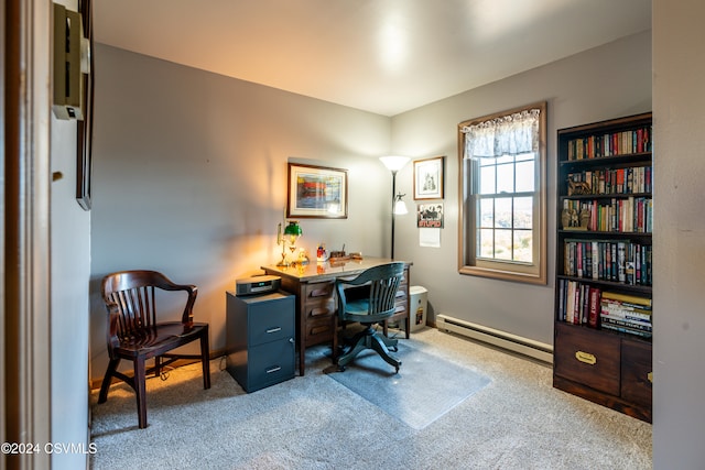 carpeted office space with a baseboard heating unit