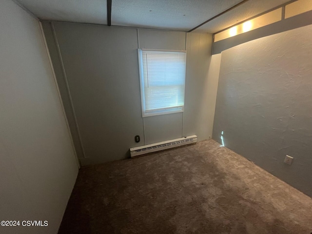 carpeted empty room featuring a textured ceiling and baseboard heating