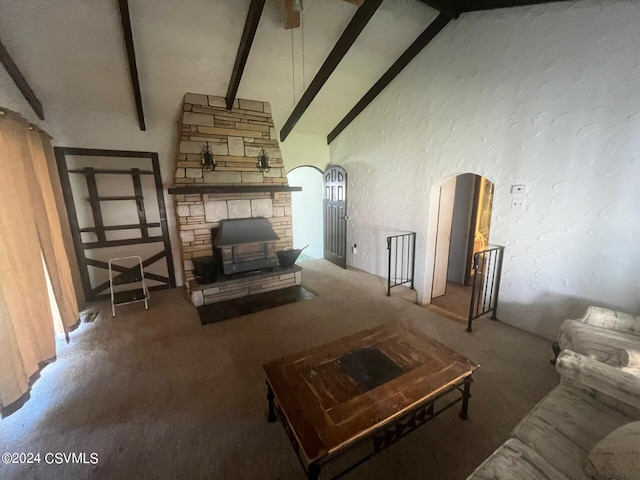 living room featuring carpet, beam ceiling, high vaulted ceiling, and a wood stove